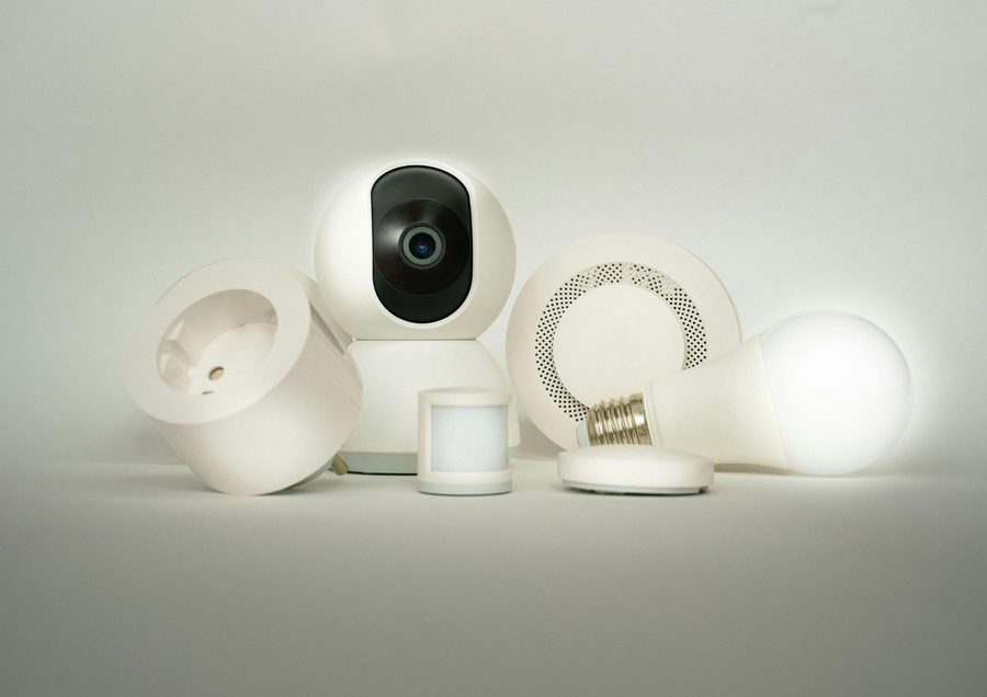 An indoor camera alongside smart sensors, a siren and a smart bulb